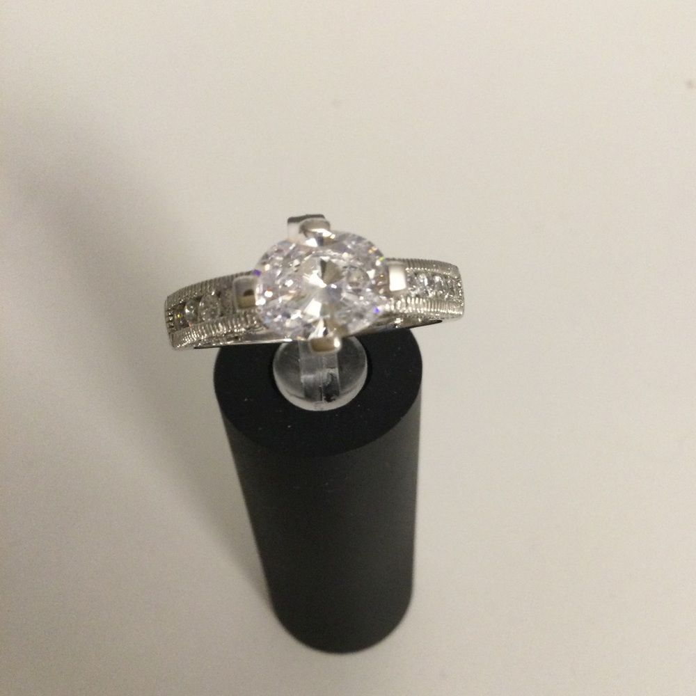 Sterling silver solitaire with Chanel set stones on sides. Vanna K in size 10
